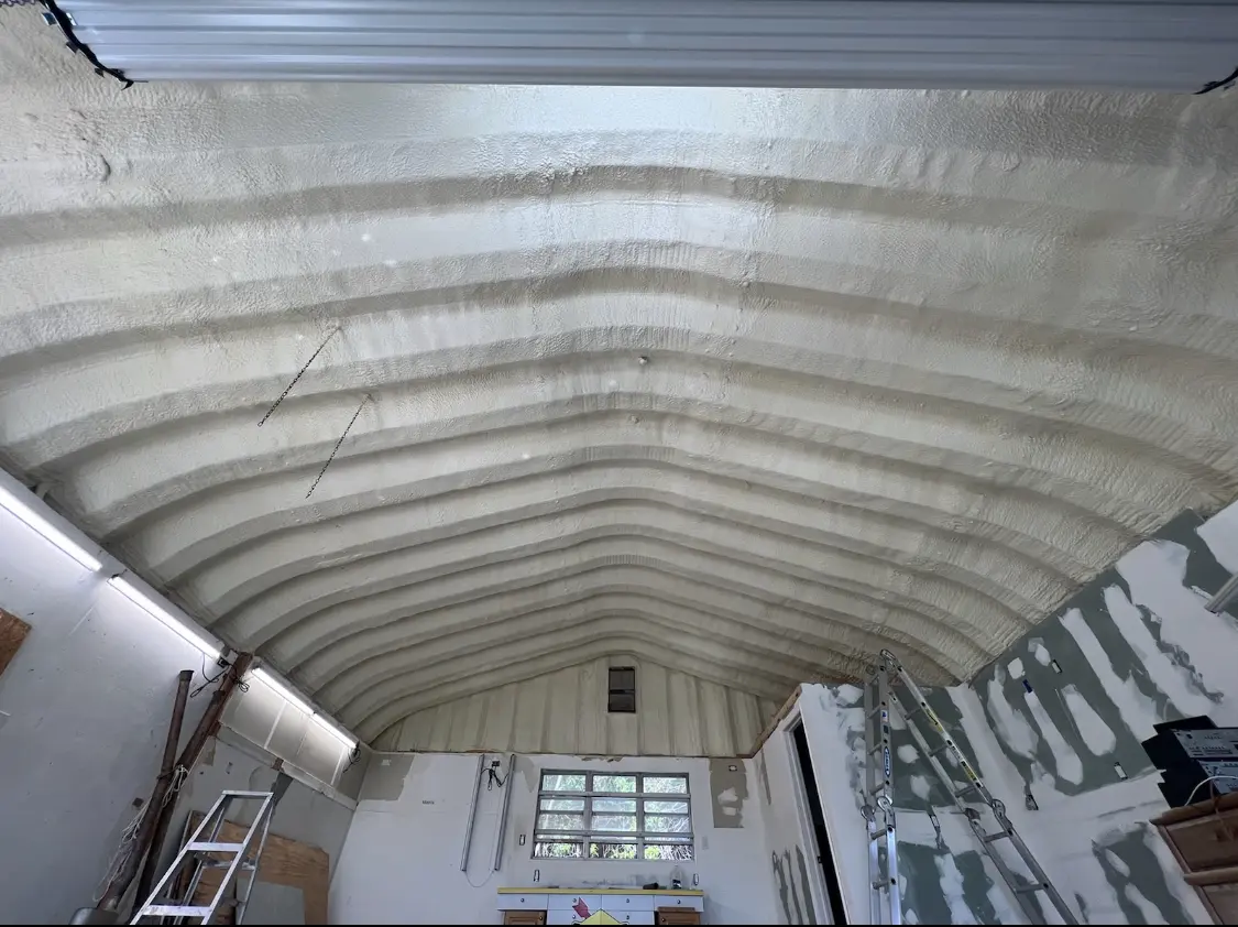 Spray polyurethane foam applied to the underside of a metal roof deck in Finley